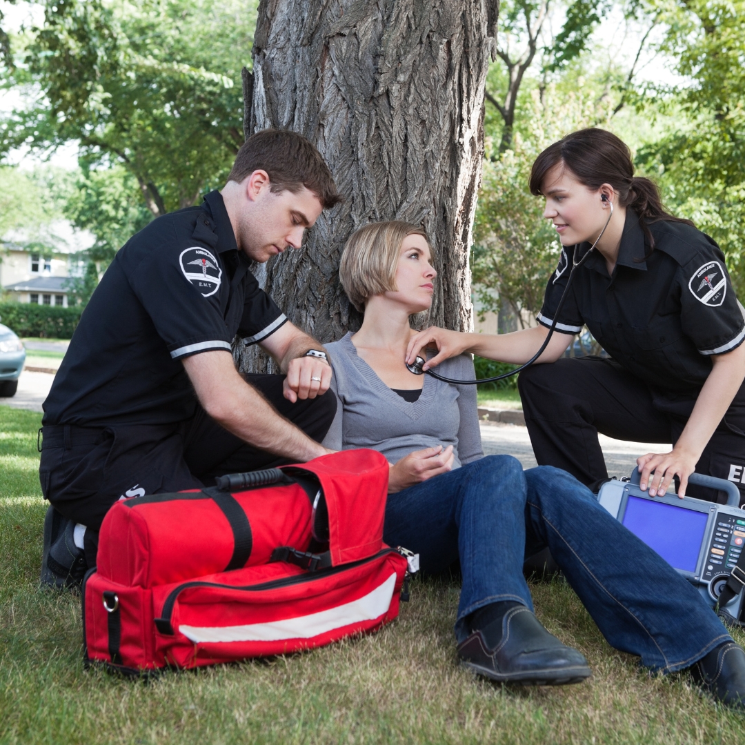 emts helping patient in park