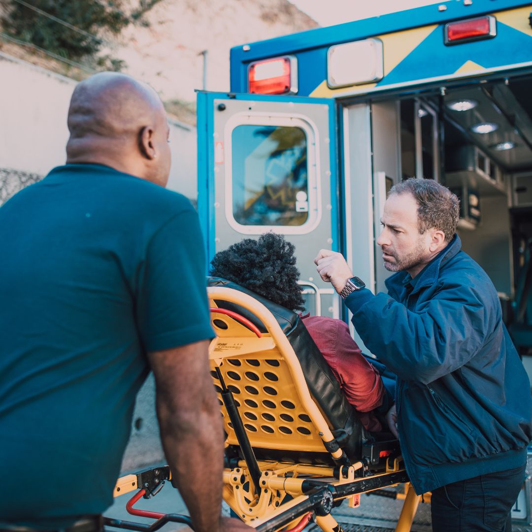 a woman being loaded into an ambulance